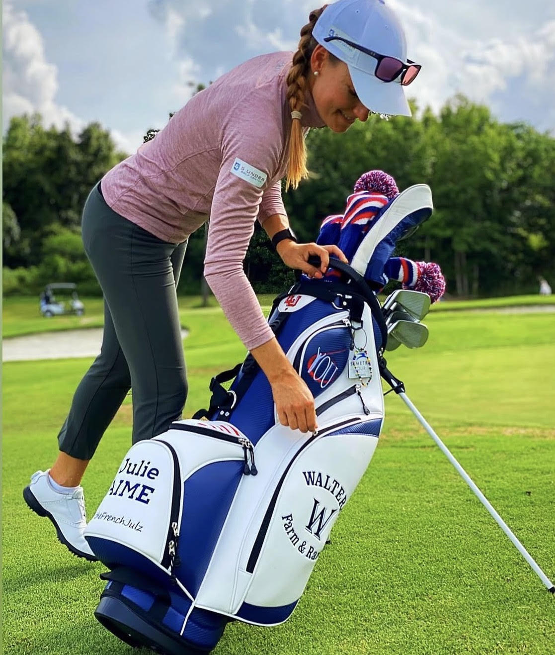 Lady Golfer with custom embroidered logos golf stand bag on the golf course
