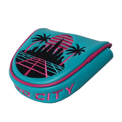 Teal and pink mallet putter cover with 'Turbo City' text and palm tree design